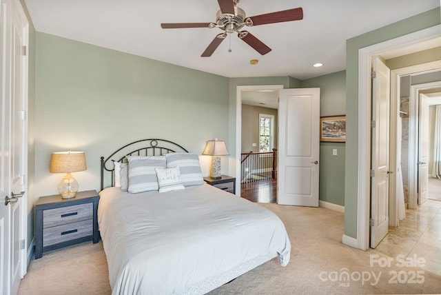 bedroom featuring recessed lighting, light colored carpet, baseboards, and ceiling fan