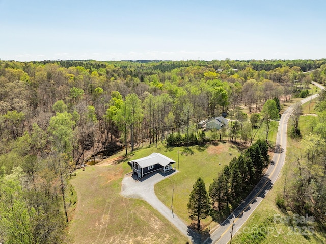 birds eye view of property featuring a wooded view