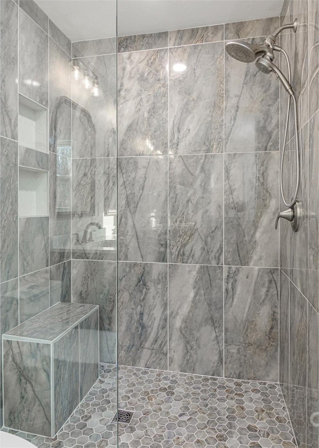 full bathroom with a tile shower