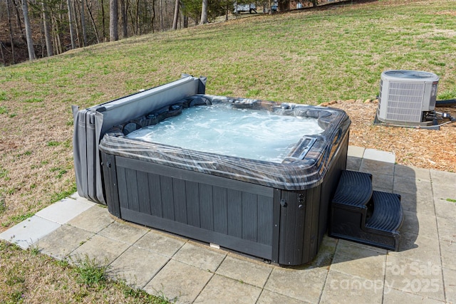 exterior space featuring a hot tub and central air condition unit