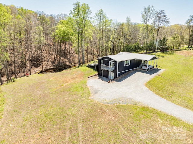 bird's eye view with a wooded view