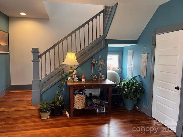 interior space with baseboards and wood finished floors