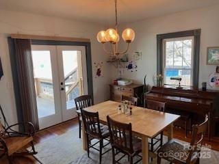 dining space featuring an inviting chandelier and wood finished floors