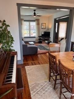 dining space featuring wood finished floors and a ceiling fan