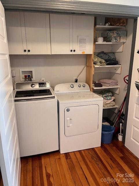 clothes washing area with cabinet space, independent washer and dryer, and wood finished floors