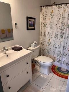 full bath featuring curtained shower, toilet, vanity, and tile patterned flooring