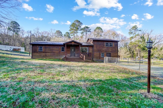 view of front of home with a front yard and fence