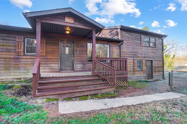 view of front of house featuring a porch and a gate