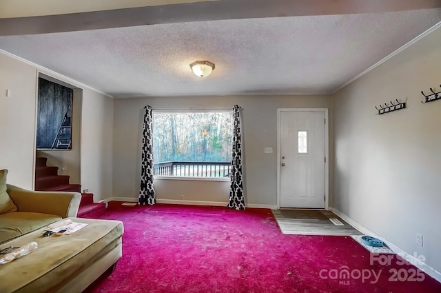 living area featuring stairway, baseboards, a textured ceiling, and crown molding