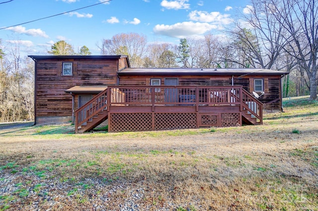 back of property with stairway, a lawn, and a wooden deck