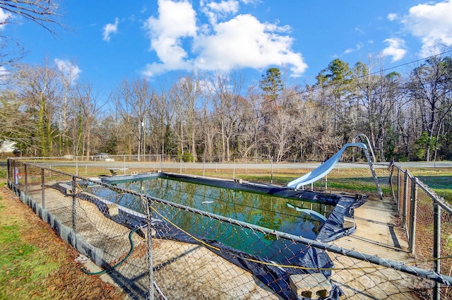 view of pool featuring fence