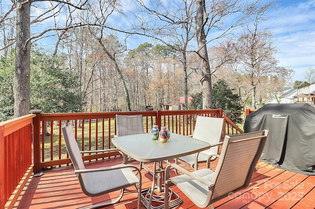 deck featuring grilling area and outdoor dining space