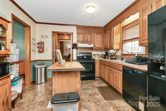 kitchen featuring wallpapered walls, a sink, black appliances, under cabinet range hood, and crown molding