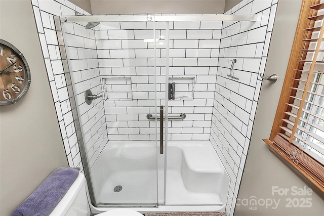 full bath with a stall shower and toilet