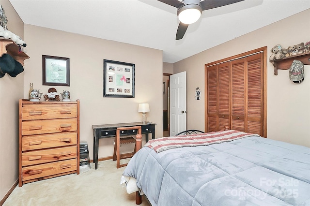 bedroom featuring a closet, baseboards, light colored carpet, and ceiling fan