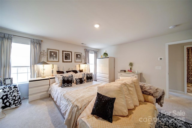 bedroom featuring recessed lighting, multiple windows, light carpet, and baseboards