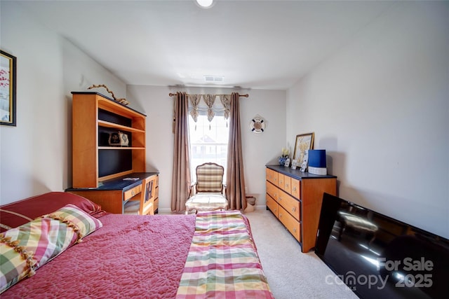bedroom featuring visible vents and light colored carpet