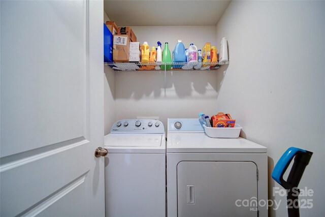 washroom featuring laundry area and washing machine and dryer
