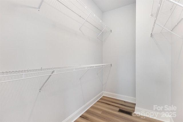walk in closet with visible vents and light wood-style flooring