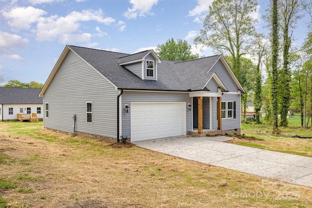 view of front of house featuring a shingled roof, a garage, driveway, and a front lawn