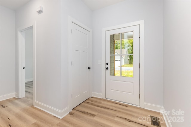 entryway featuring light wood-style floors and baseboards