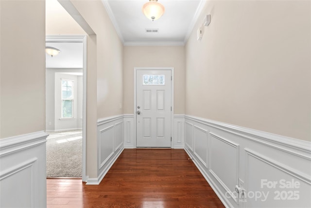 3104 Streamhaven Dr, Indian Land, SC 29707 - doorway featuring visible vents, a wainscoted wall, ornamental molding, and dark wood finished floors