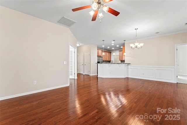 3104 Streamhaven Dr, Indian Land, SC 29707 - unfurnished living room featuring dark wood-type flooring, ceiling fan with notable chandelier, visible vents, and wainscoting