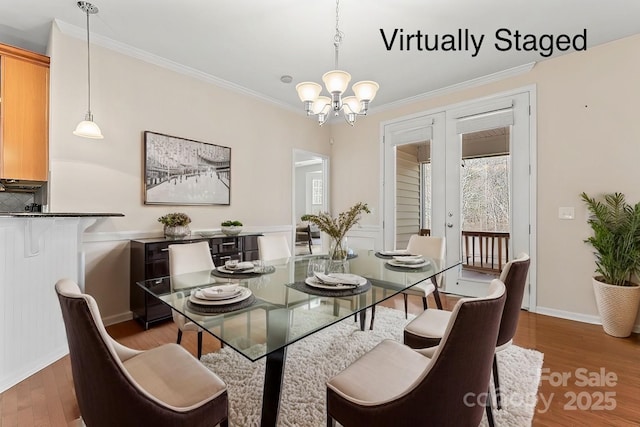 3104 Streamhaven Dr, Indian Land, SC 29707 - dining area featuring baseboards, a notable chandelier, wood finished floors, and crown molding