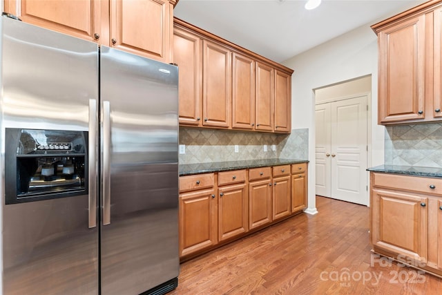 3104 Streamhaven Dr, Indian Land, SC 29707 - kitchen with dark stone counters, stainless steel fridge with ice dispenser, light wood-style floors, and backsplash