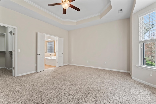 3104 Streamhaven Dr, Indian Land, SC 29707 - unfurnished bedroom featuring a walk in closet, multiple windows, a raised ceiling, and carpet floors