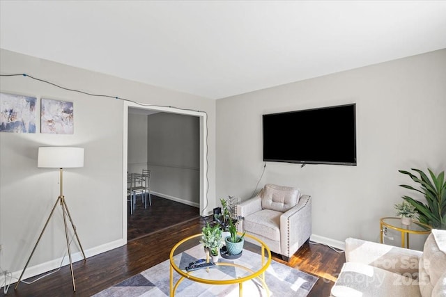 living room featuring wood finished floors and baseboards