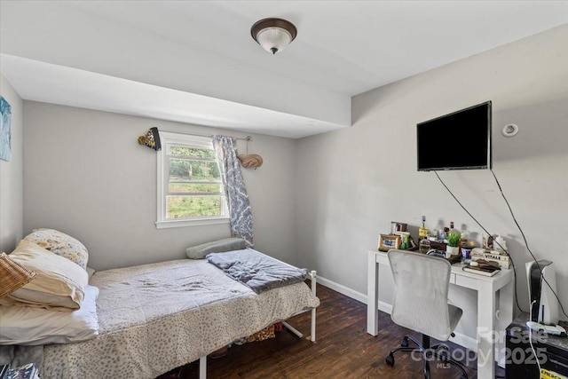 bedroom with baseboards and wood finished floors