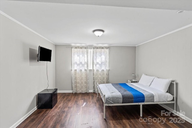 bedroom with baseboards, ornamental molding, and dark wood-style flooring