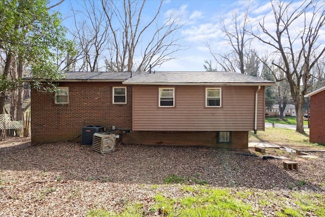 rear view of house with central AC unit