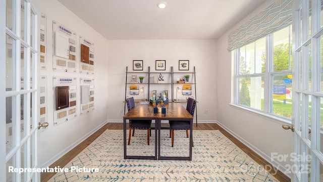 dining room featuring french doors, baseboards, and dark wood-type flooring