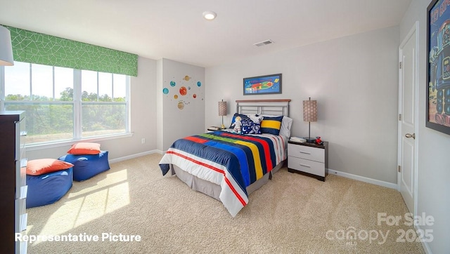 carpeted bedroom featuring visible vents and baseboards