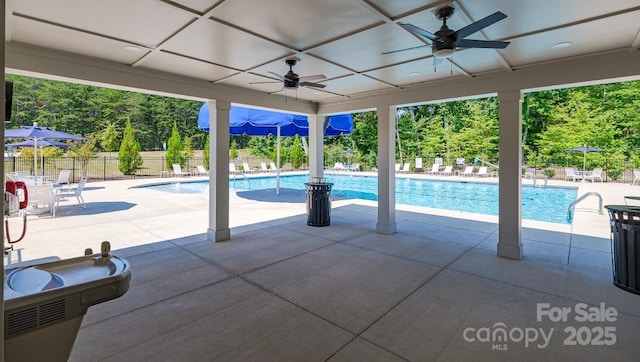 pool featuring a ceiling fan, a patio area, and fence