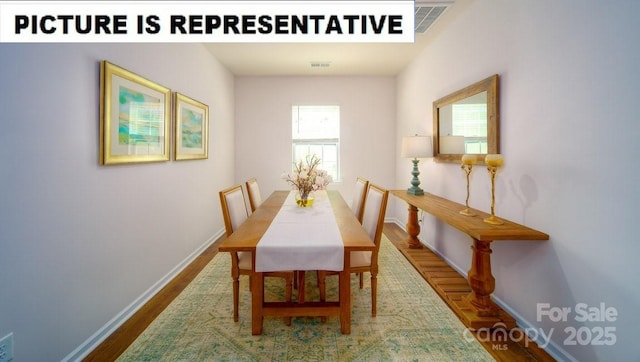 dining room with wood finished floors, visible vents, and baseboards