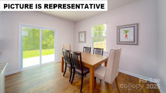 dining room featuring wood finished floors and baseboards