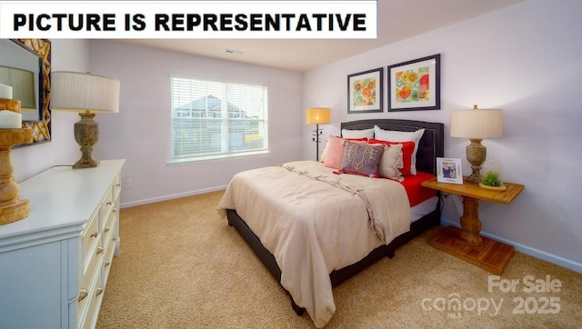 bedroom featuring light colored carpet and baseboards