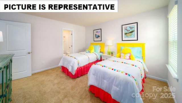 bedroom with baseboards, ensuite bathroom, and carpet