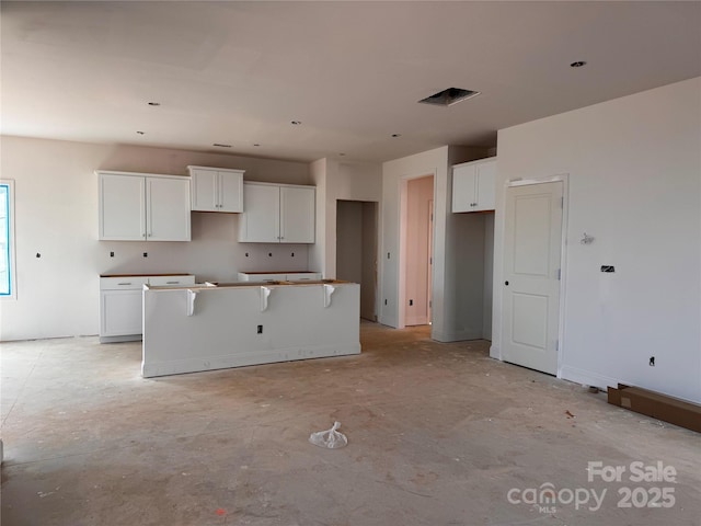 713 Inwood Hill Dr Unit 96, Gastonia, NC 28056 - kitchen with a kitchen island and white cabinets