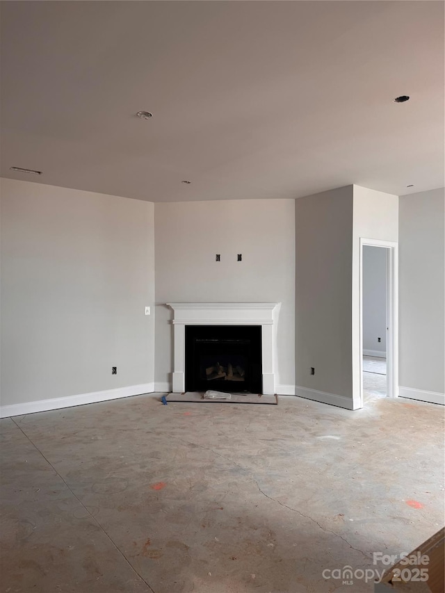 713 Inwood Hill Dr Unit 96, Gastonia, NC 28056 - unfurnished living room with concrete floors, a fireplace with raised hearth, and baseboards