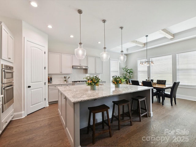 873 Penny Royal Ave, Fort Mill, SC 29715 - kitchen with dark wood-type flooring, plenty of natural light, an island with sink, recessed lighting, and beamed ceiling