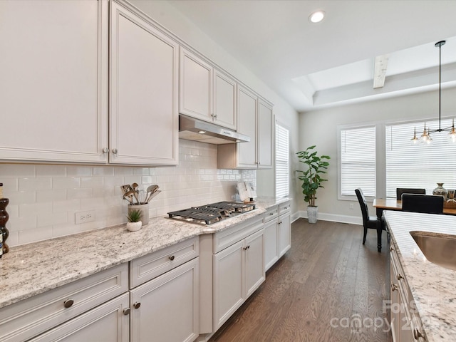 873 Penny Royal Ave, Fort Mill, SC 29715 - kitchen featuring stainless steel gas stovetop, under cabinet range hood, dark wood-type flooring, backsplash, and a raised ceiling