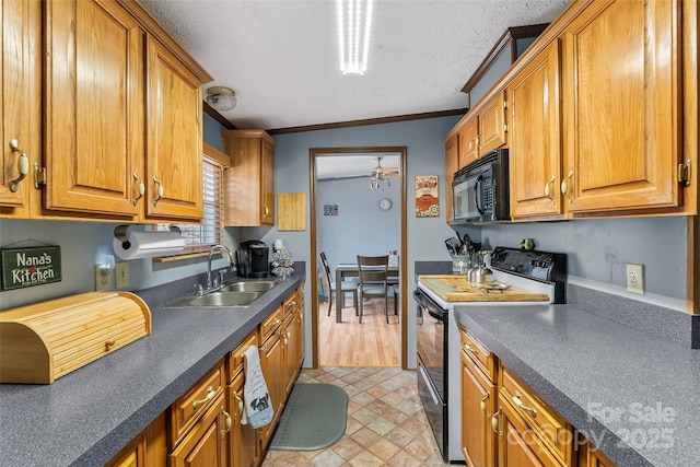 kitchen with a sink, brown cabinetry, black microwave, and electric stove