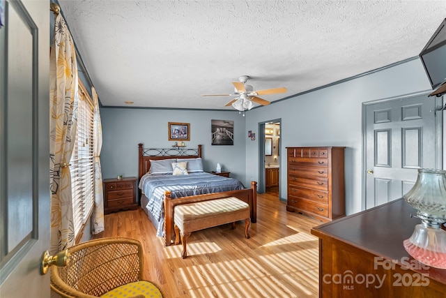 bedroom featuring connected bathroom, a textured ceiling, ceiling fan, and light wood finished floors