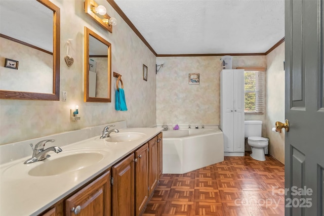 full bathroom with a sink, toilet, a bath, and a textured ceiling