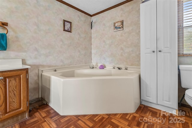 full bathroom with a garden tub, toilet, crown molding, and a textured ceiling