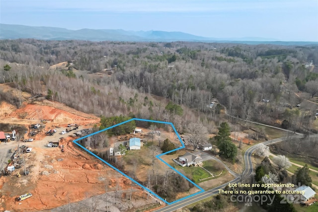 aerial view featuring a mountain view and a forest view